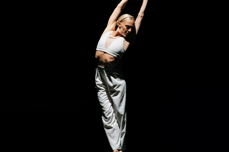 Ballerina in an elegant pose on stage during Plie for the Arts in Kingston, Jamaica.