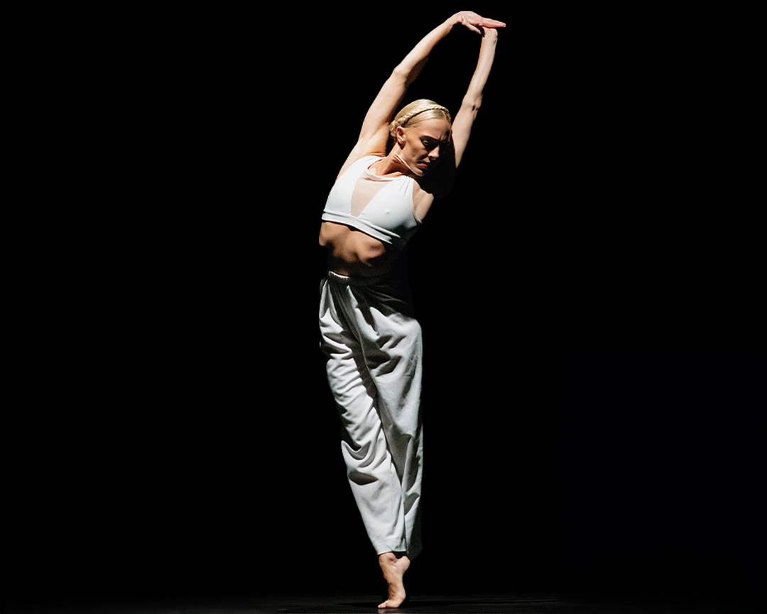 Ballerina in an elegant pose on stage during Plie for the Arts in Kingston, Jamaica.